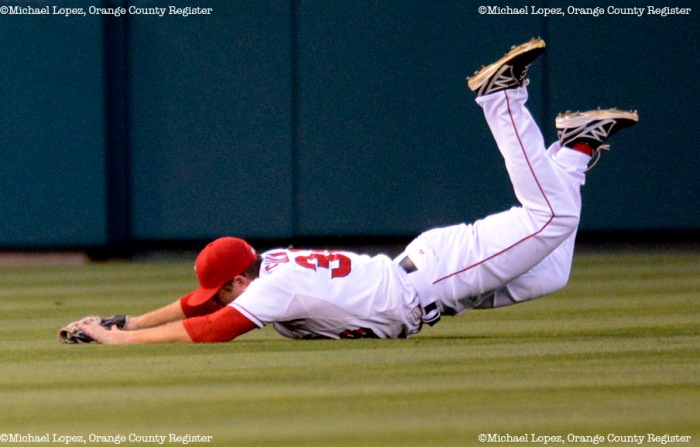 Angels Mike Trout dives for the ball but comes up short in his game against the Twins Monday at Angel Stadium. – 7/22/13 – MICHAEL LOPEZ, ORANGE COUNTY REGISTER –  