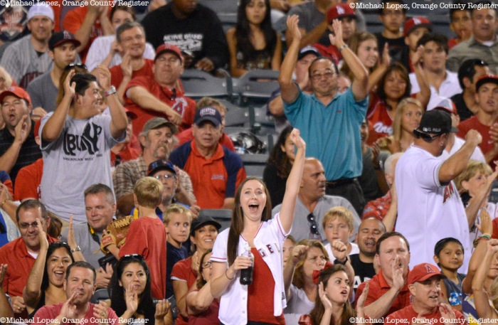 Angel fans celebrate after the out at home against the Twins Monday at Angel Stadium. – 7/22/13 – MICHAEL LOPEZ, ORANGE COUNTY REGISTER –  