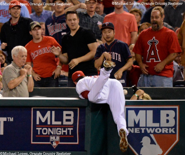 Angels Brad Hawpe goes into the stand attempting to catch a foul ball in their game against the Twins Monday at Angel Stadium. – 7/22/13 – MICHAEL LOPEZ, ORANGE COUNTY REGISTER – 