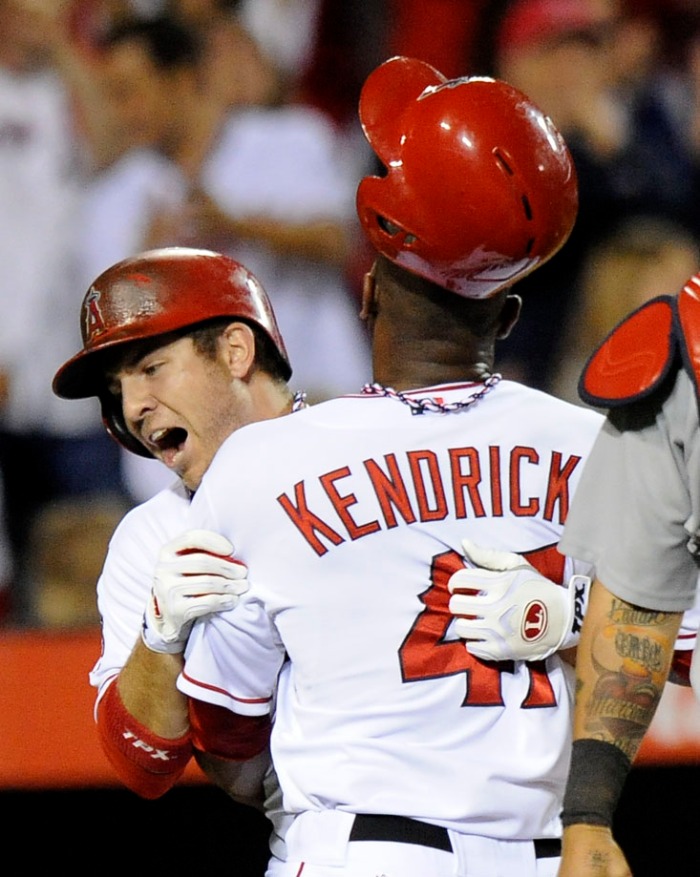 Angels' Mark Trumbo and Howard Kendrick celebrate at home base after beating the Cardinals 6-5 Thursday at Anaheim Stadium.   – 6/02/13 – MICHAEL LOPEZ, ORANGE COUNTY REGISTER –  
