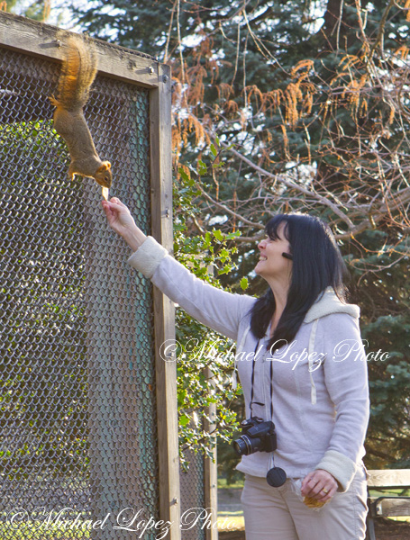 Sherry Roberts feeds a squirrel for the first time at Pioneer Park by the aviary.