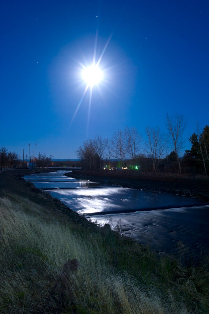 The moonlight reflects on the running water of Mill Creek river Tuesday night by Walla Walla Community College in Walla Walla, Wa. 03 March 2015, (AP photo/WALLA WALLA UNION-BULLETIN, MICHAEL LOPEZ)