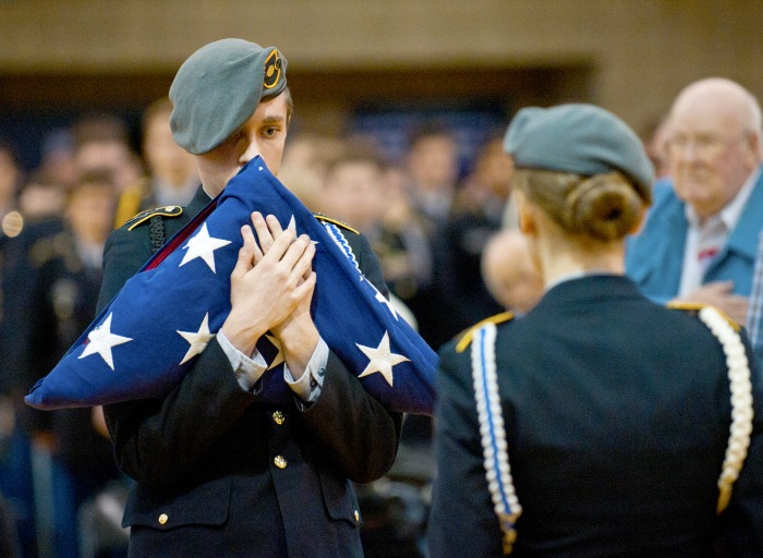 JROTC's Mason Christopher carries the folded flag to a fellow cadet to be placed on the Fallen Soldier display during the Veterans Day assembly at Wa-Hi in Walla Walla, Wa. November 10 (MICHAEL LOPEZ/Walla Walla,-Union Bulletin via AP)